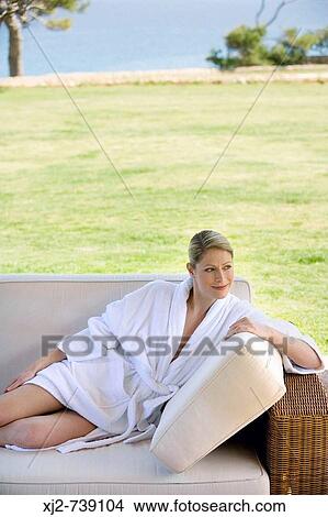Picture - Woman in bathrobe relaxing at home. Fotosearch