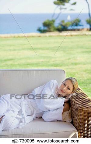 Woman in bathrobe relaxing outdoors View Large Photo Image Stock Photography - Woman in bathrobe relaxing outdoors. Fotosearch