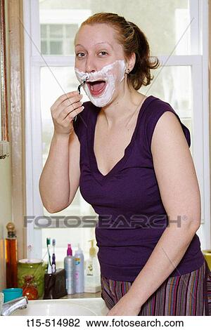 Woman in bathroom shaving like a man for fun View Large Photo Image Stock Image - Woman in bathroom shaving like a man for fun. Fotosearch