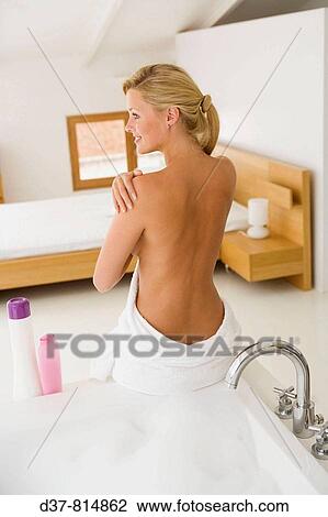 Stock Image - Woman in bathroom. Fotosearch