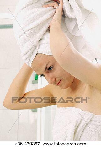 Woman in bathroom with towel on head View Large Photo Image Stock Photo - Woman in bathroom with towel on head. Fotosearch