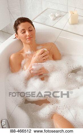 Stock Image - Woman in bathtub. Fotosearch