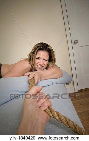 Woman in bed pulling on a rope View Large Photo Image Stock Image - Woman in bed pulling on a rope. Fotosearch