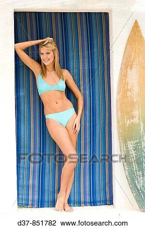 Stock Image - Woman in bikini in a beach hou. Fotosearch