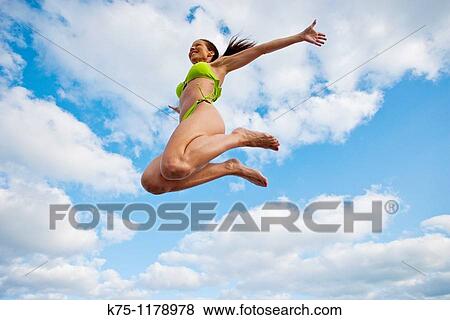 Woman in bikini, jumping View Large Photo Image Stock Photo - Woman in bikini, jumping. Fotosearch