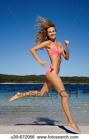 Woman in bikini, running next to a beautiful lake. Fraser Island, Australia View Large Photo Image Stock Photograph - Woman in bikini, running next to a beautiful lake. Fraser Island, Australia. Fotosearch