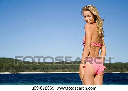 Woman in bikini standing next to a beautiful lake. Fraser Island, Australia View Large Photo Image Stock Photography - Woman in bikini standing next to a beautiful lake. Fraser Island, Australia. Fotosearch
