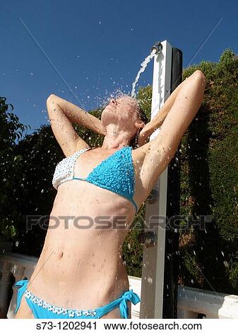 Woman in bikini using outdoor shower View Large Photo Image Stock Image - Woman in bikini using outdoor shower. Fotosearch