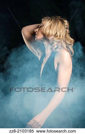 Stock Photography - Woman in black dress hand touching head.. Fotosearch