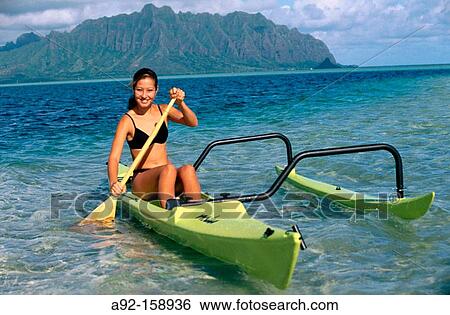Stock Photograph - Woman in canoe. Oahu Island. Hawaii. USA. Fotosearch