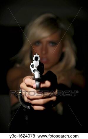 Woman in fear pointing a gun at viewer View Large Photo Image Stock Photo - Woman in fear pointing a gun at viewer. Fotosearch