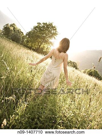 Woman in field View Large Photo Image Stock Image - Woman in field. Fotosearch