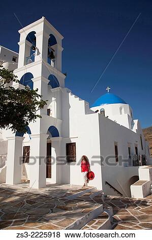 Stock Photo - Woman in front of a blue domed church, Panagia Gremiotissa church in town center Chora, Ios, Cyclades Islands, Greek Islands, Greece, Europe.. Fotosearch