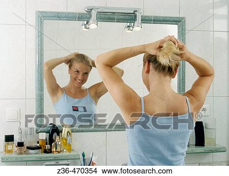 Picture - Woman in front of mirror. Fotosearch