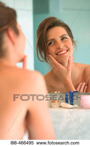 Stock Photography - Woman in front of mirror. Fotosearch