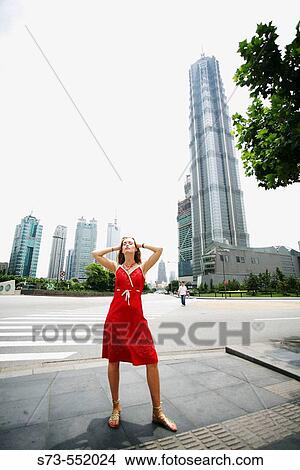 Woman in front of Shanghai Financial Center. Shanghai (Pudong), China View Large Photo Image Picture - Woman in front of Shanghai Financial Center. Shanghai (Pudong), China. Fotosearch