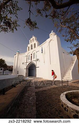 Woman in front of the St. Mary's Church with a two-storey bell tower from 1660, Pyrgos, Santorini, Cyclades Islands, Greek Islands, Greece, Europe. View Large Photo Image Stock Image - Woman in front of the St. Mary's Church with a two-storey bell tower from 1660, Pyrgos, Santorini, Cyclades Islands, Greek Islands, Greece, Europe.. Fotosearch