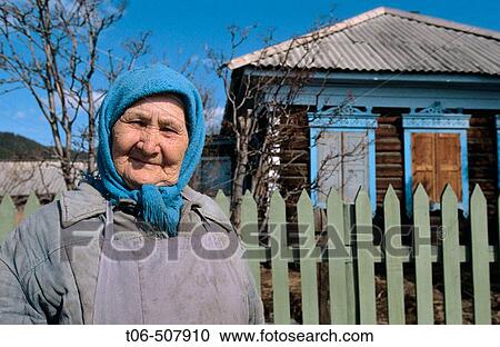 Woman in front of wooden house, Rougir village, Olhkon Island, Baikal lake, Siberia, Russia View Large Photo Image Stock Image - Woman in front of wooden house, Rougir village, Olhkon Island, Baikal lake, Siberia, Russia. Fotosearch