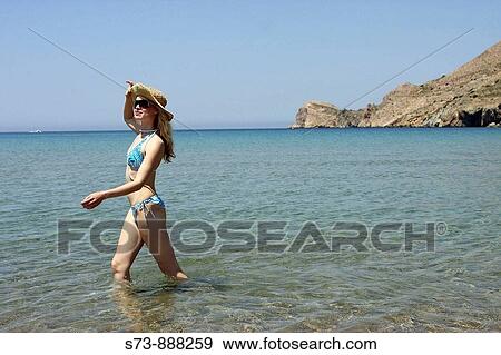 Stock Photo - Woman in Galissa beach, Syros, Cyclades Islands, Greece. Fotosearch
