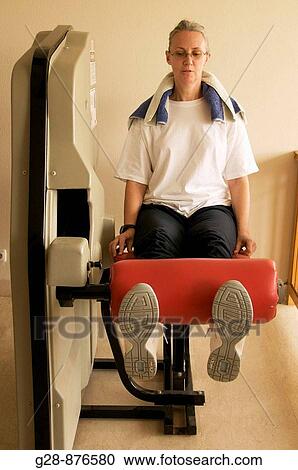 Stock Image - Woman in gym. Fotosearch