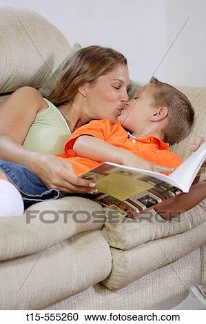 Woman in her 20's and reading to her son bonding with him and shared a happy kiss View Large Photo Image Stock Image - Woman in her 20's and reading to her son bonding with him and shared a happy kiss. Fotosearch