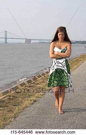 woman in her 20's walking along a river bank pondering, contemplating and looking depressed and mad View Large Photo Image Stock Photograph - woman in her 20's walking along a river bank pondering, contemplating and looking depressed and mad. Fotosearch