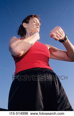 Stock Photograph - Woman in her 50's working out running. Fotosearch