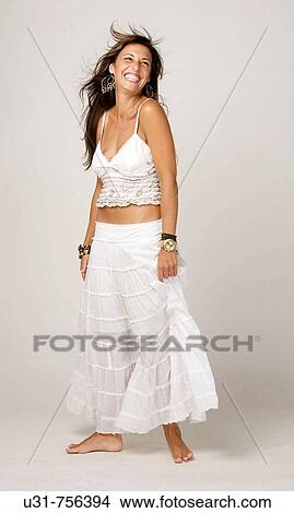 Picture - Woman in her early 40s with wind in her hair smiling. Fotosearch