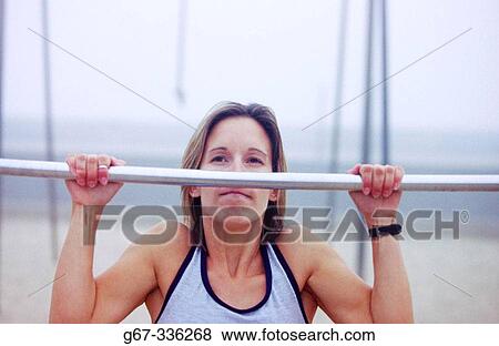 Woman in her mid 20's doing pull ups. Venice. California. USA. View Large Photo Image Stock Photo - Woman in her mid 20's doing pull ups. Venice. California. USA.. Fotosearch