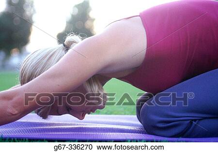 Woman in her mid 20's doing yoga in the park. Santa Monica. California. USA. View Large Photo Image Stock Image - Woman in her mid 20's doing yoga in the park. Santa Monica. California. USA.. Fotosearch