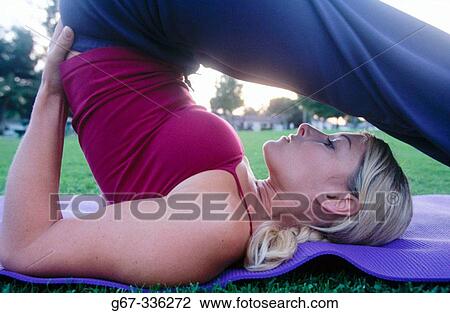 Woman in her mid 20's doing yoga in the park. Santa Monica. California. USA. View Large Photo Image Stock Image - Woman in her mid 20's doing yoga in the park. Santa Monica. California. USA.. Fotosearch