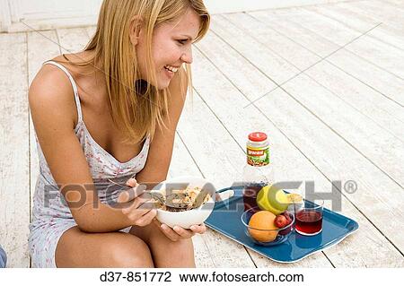 Woman in her pyjamas having cereals View Large Photo Image Stock Image - Woman in her pyjamas having cereals. Fotosearch