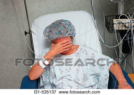 Woman in Hospital waiting and being preped for operation on injured damaged knees by doctor with some electronics View Large Photo Image Stock Photo - Woman in Hospital waiting and being preped for operation on injured damaged knees by doctor with some electronics. Fotosearch
