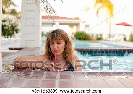 Woman in hot tub at a swimming pool area of a hotel View Large Photo Image Stock Photo - Woman in hot tub at a swimming pool area of a hotel. Fotosearch