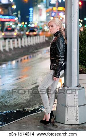 Woman in leather jacket against lamp post, Times Square New York View Large Photo Image Picture - Woman in leather jacket against lamp post, Times Square New York. Fotosearch