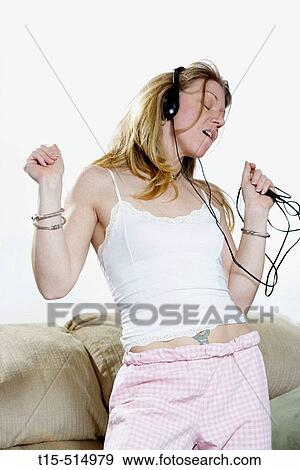 Woman in living room dancing listening to music View Large Photo Image Stock Photo - Woman in living room dancing listening to music. Fotosearch