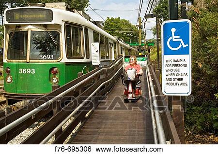 Woman in motorized chair using ramp for public transprtation in Newton, MA, USA View Large Photo Image Stock Photograph - Woman in motorized chair using ramp for public transprtation in Newton, MA, USA. Fotosearch