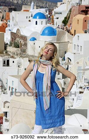 Stock Image - Woman in Oia, Santorini, Cyclades Islands, Greece. Fotosearch