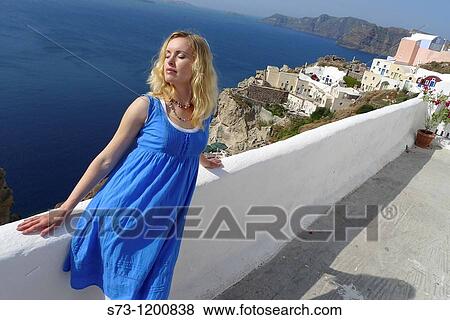 Stock Photo - Woman in Oia, Santorini, Cyclades Islands, Greece. Fotosearch