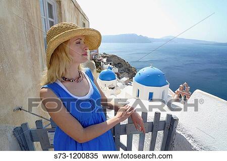 Stock Photography - Woman in Oia, Santorini, Cyclades Islands, Greece. Fotosearch