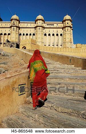 Woman in orange sari walking up to Amber Fort Jaipur India View Large Photo Image Stock Photo - Woman in orange sari walking up to Amber Fort Jaipur India. Fotosearch
