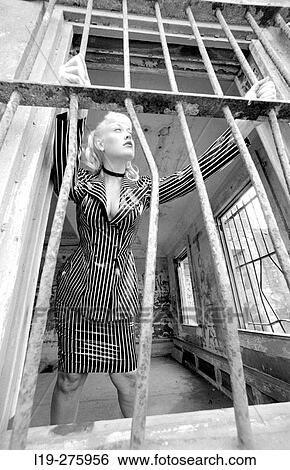 Stock Photograph - woman in pinstripe suit in jail. Fotosearch
