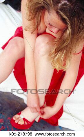 Woman in red dress tying red sandals View Large Photo Image Stock Photo - Woman in red dress tying red sandals. Fotosearch
