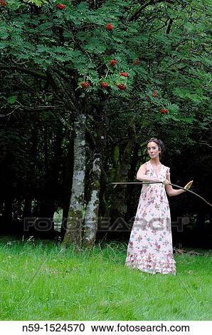 Stock Image - Woman in rural setting. Fotosearch