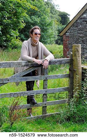 Woman in rural setting View Large Photo Image Stock Photo - Woman in rural setting. Fotosearch