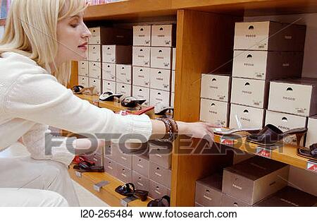 Woman in shoe store View Large Photo Image Picture - Woman in shoe store. Fotosearch