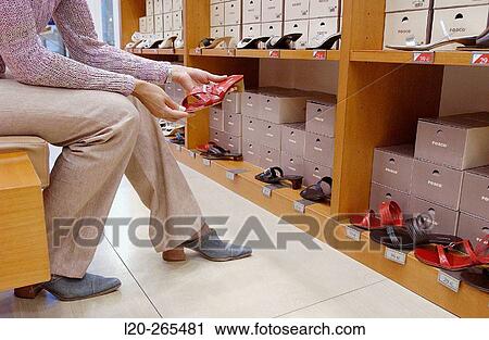 Woman in shoe store View Large Photo Image Stock Image - Woman in shoe store. Fotosearch
