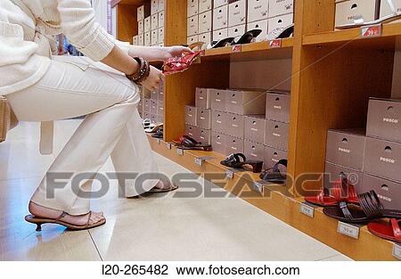Woman in shoe store View Large Photo Image Stock Image - Woman in shoe store. Fotosearch