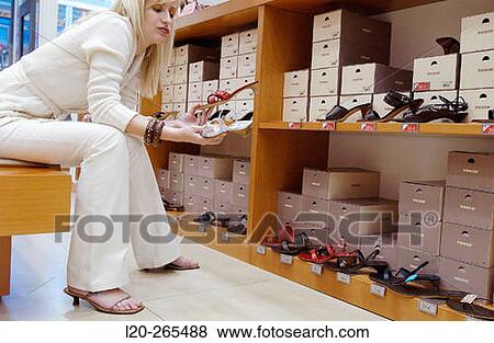 Woman in shoe store View Large Photo Image Stock Photo - Woman in shoe store. Fotosearch