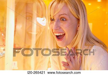Woman in shopping center, looking at jewelry View Large Photo Image Stock Image - Woman in shopping center, looking at jewelry. Fotosearch